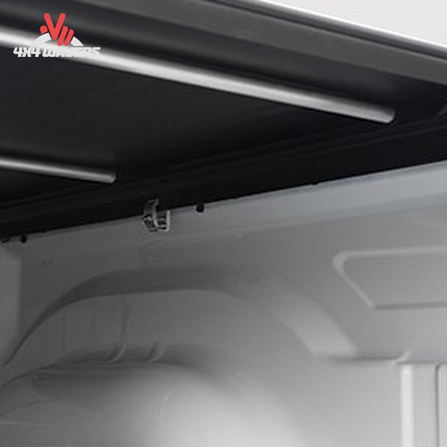 Close-up of the interior ceiling and upper side panel of a white vehicle cargo space or van, showing a black trim strip, mounting hardware.