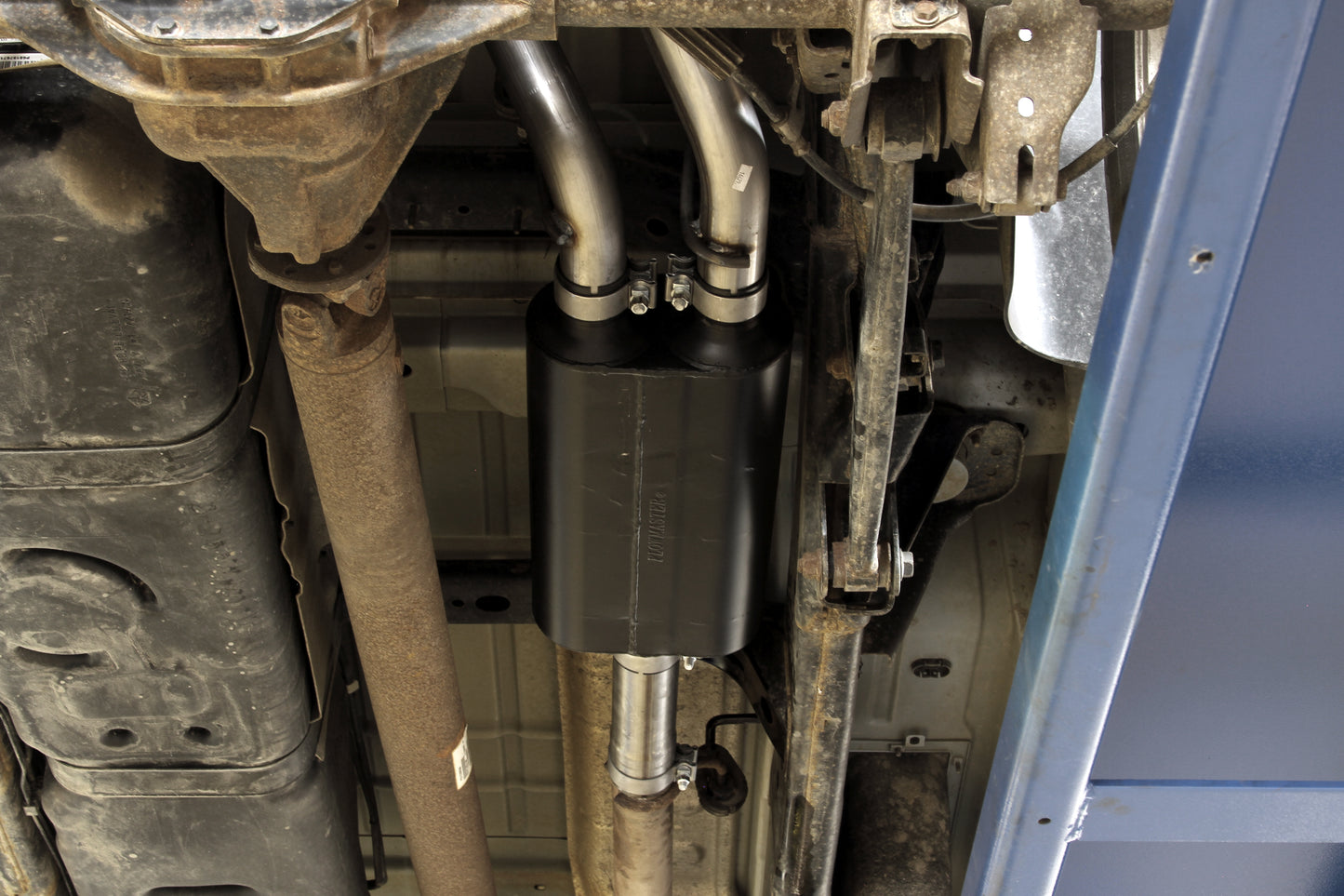 Flowmaster American Thunder cat-back exhaust system kit displayed, featuring polished stainless steel pipes and performance mufflers.