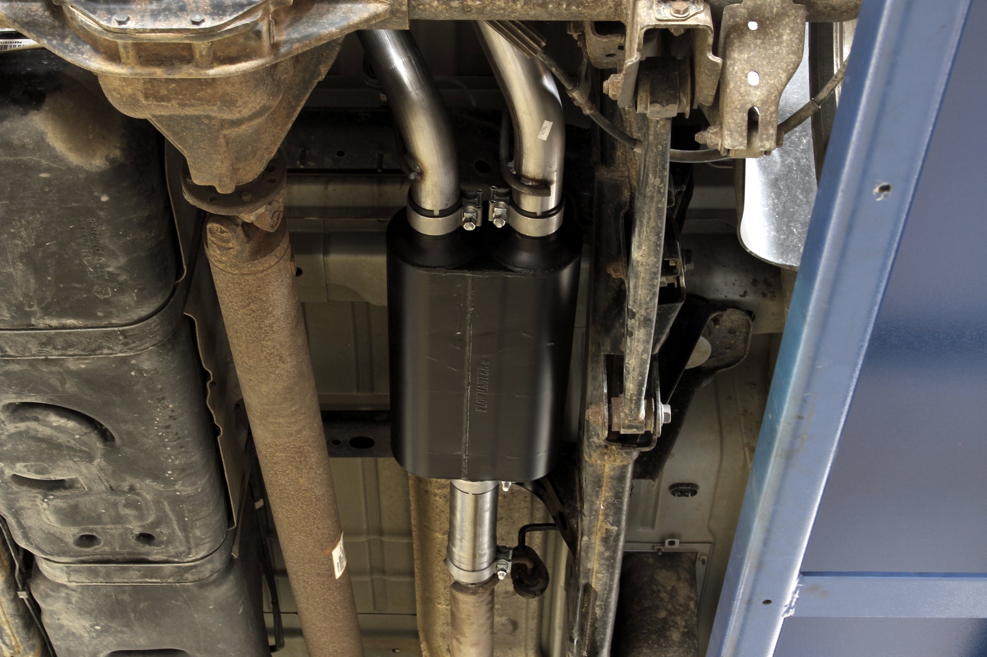 Flowmaster American Thunder cat-back exhaust system kit displayed, featuring polished stainless steel pipes and performance mufflers.