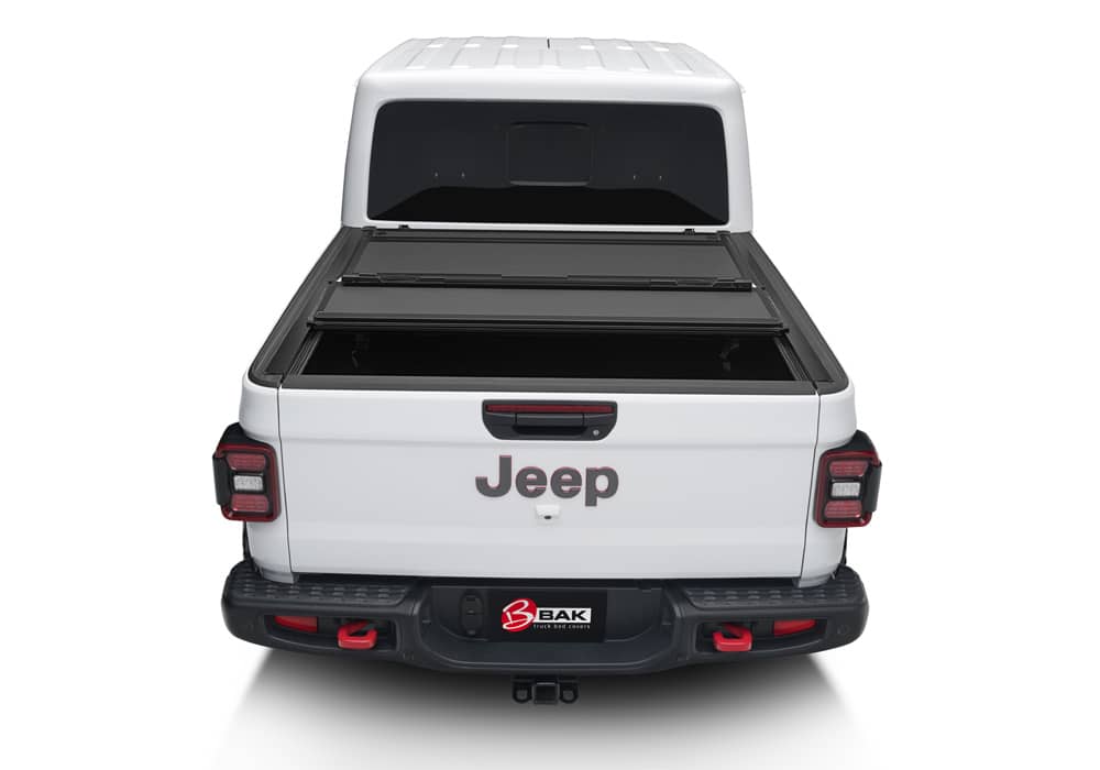 Matte aluminum BAKFlip MX4 hard folding tonneau cover on Jeep Gladiator 5ft bed, featuring tailgate lock system and 400lb capacity.