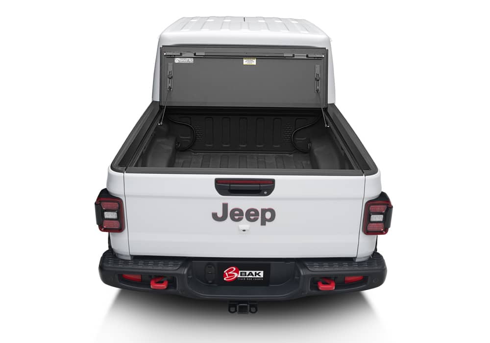 BAK MX4 hard folding tonneau cover in matte aluminum installed on Jeep Gladiator 5ft bed, featuring tailgate lock system and 400lb capacity