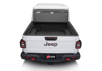 BAK MX4 hard folding tonneau cover in matte aluminum installed on Jeep Gladiator 5ft bed, featuring tailgate lock system and 400lb capacity