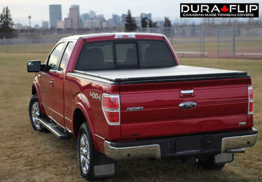Dura-Flip DURA FLIP 04-14 F150 6.5' tonneau cover installed on a pickup truck, showing the sleek black design and secure latch system.