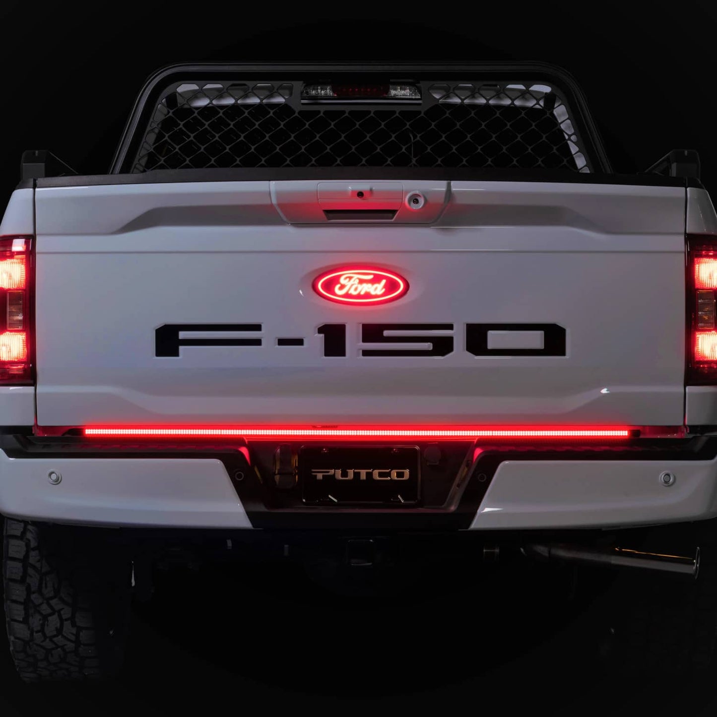 Putco 60-inch silver tailgate light bar kit installed on Silverado/Sierra 2020-2026, showcasing LED light strip on truck tailgate.