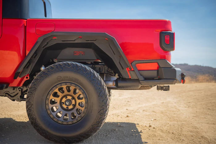 Front view of 2019-2026 Jeep Gladiator JT rear fender flares by 4X4 Wavers, showing the black plastic design and attachment points.