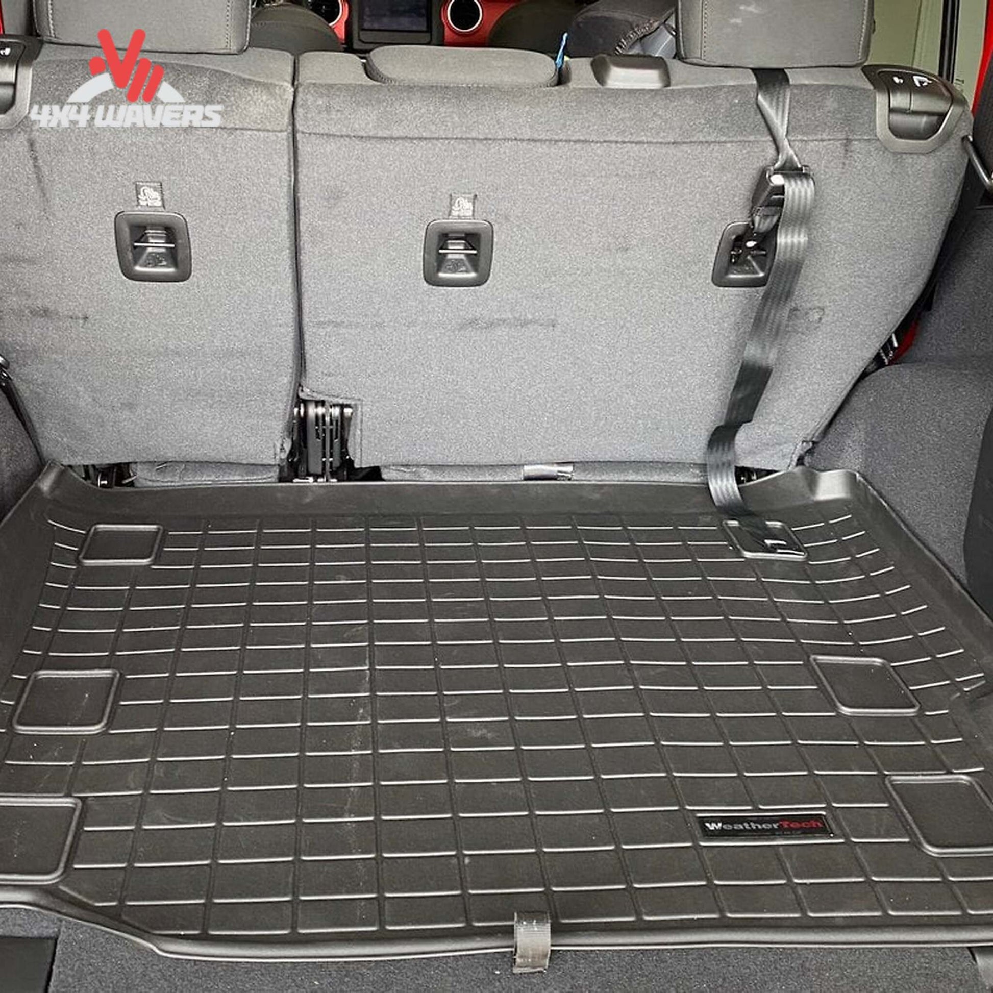 Close-up of the raised perimeter wall engineered to contain water mud snow and debris inside the cargo liner