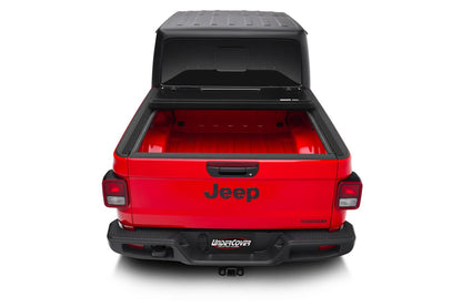 Undercover FLEX BOX CVR 20-26 Gladiator 5' tonneau cover installed on a truck bed, showcasing its durable design and secure fit.