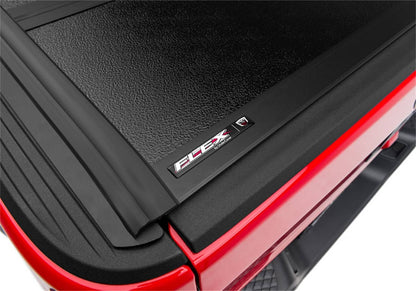 Undercover FLEX BOX CVR 20-26 Gladiator 5' tonneau cover installed on a pickup truck, showcasing durable protective cover design