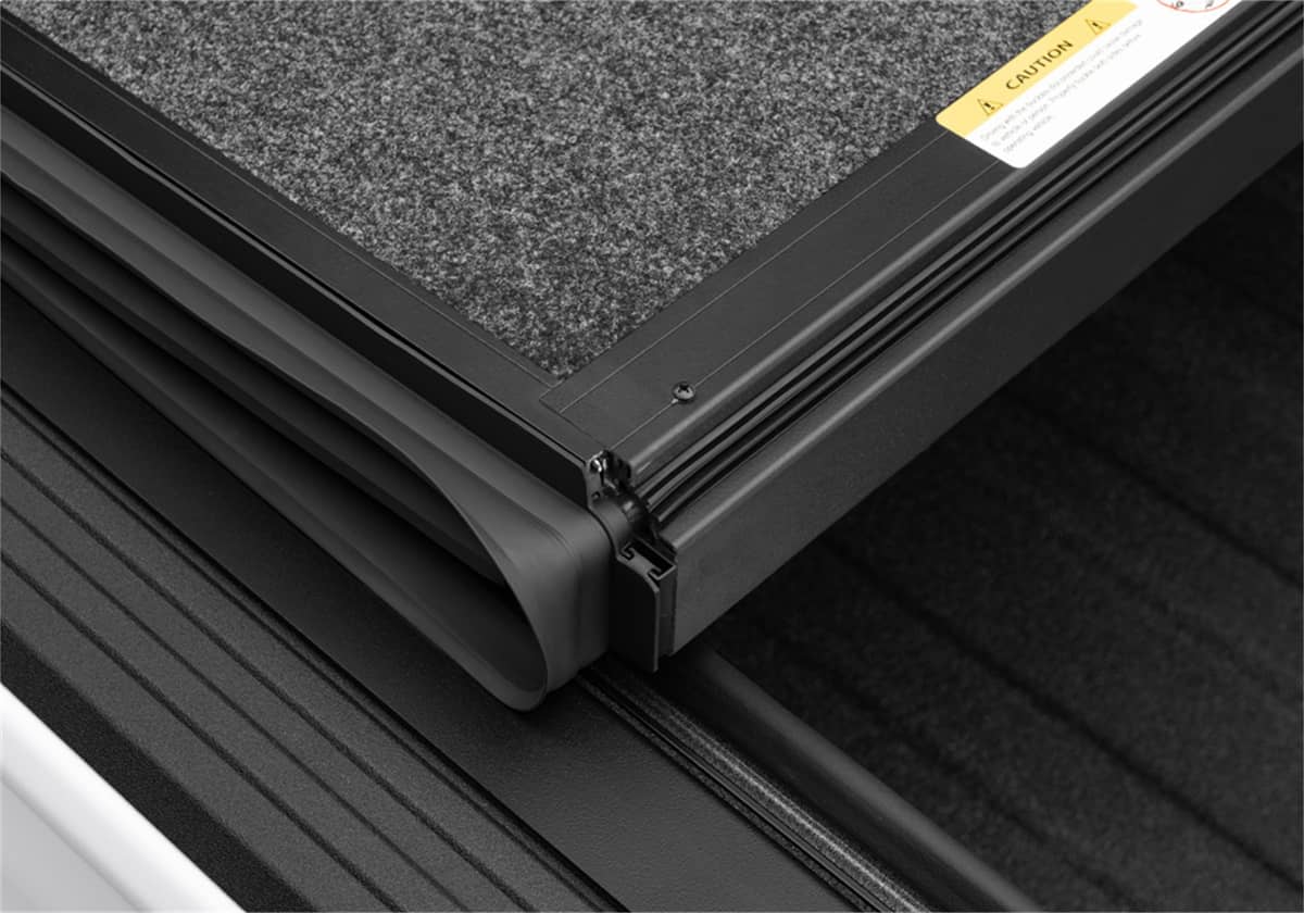 Undercover Ultra Flex Box CVR 20-26 Gladiator 5' tonneau cover with black weather-resistant material and secure side clamps.