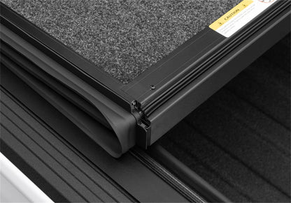 Undercover Ultra Flex Box CVR 20-26 Gladiator 5' tonneau cover with black weather-resistant material and secure side clamps.