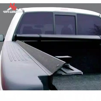 An ultra low profile 1 inch black vinyl soft roll up truck bed cover installed on a short box Ford F-150 Lightning SKU BGPC_41369.