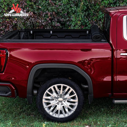 A 5.5 foot soft vinyl tonneau cover completely rolled up behind the truck cab showing full open bed access SKU BGPC_41369.