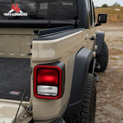 The soft vinyl tonneau cover completely rolled up behind the truck cab window for full cargo space access.