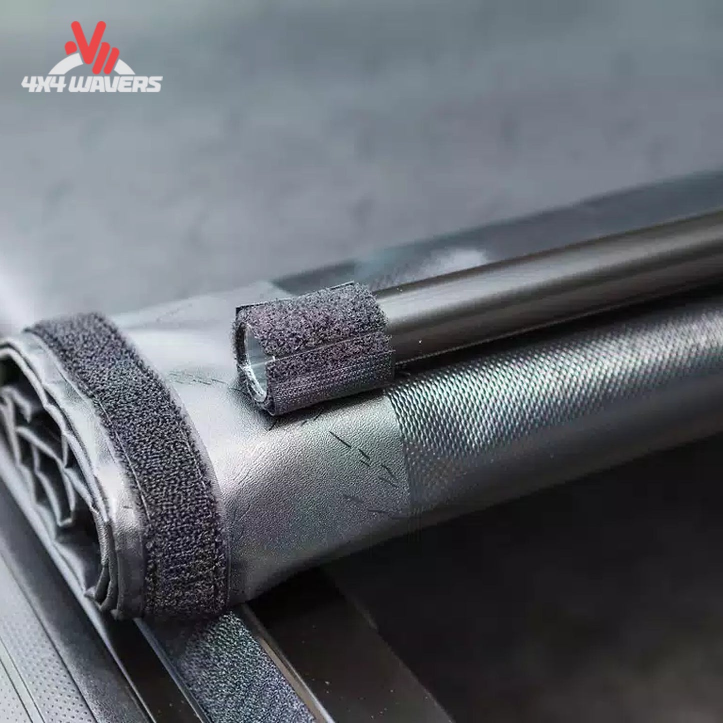 Close-up detail of the automated structural side latch system that secures the roll up tonneau cover near the tailgate.