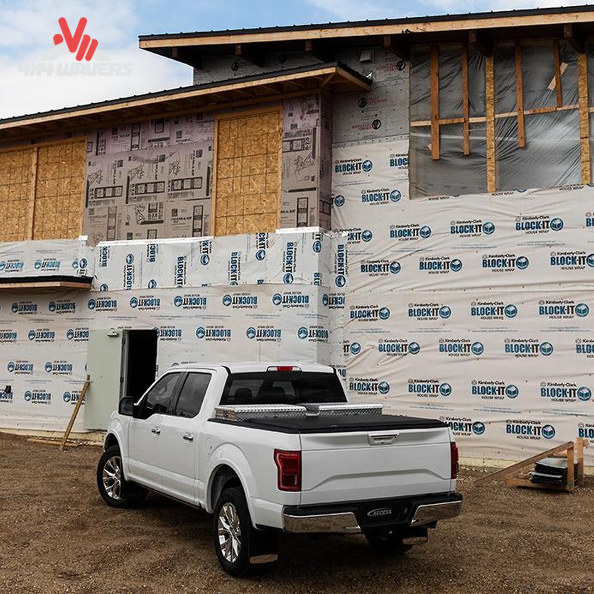 A soft roll up vinyl tonneau cover mounted behind a crossover toolbox on a 6.5 foot standard box Ford F-150 SKU BGPC_61379.