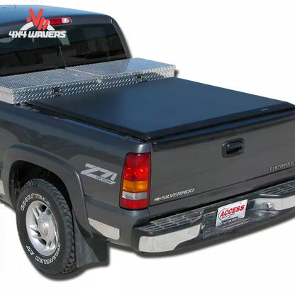 A commercial grade soft roll up vinyl tonneau cover mounted behind a crossover toolbox on an 8 foot long box Ford F-150 work truck SKU BGPC_61389.