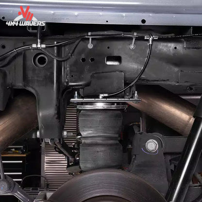 Close-up detail of an air helper spring mounted between the frame and rear leaf spring axle on a Ford F-150 PowerBoost truck SKU BBCG_57389.