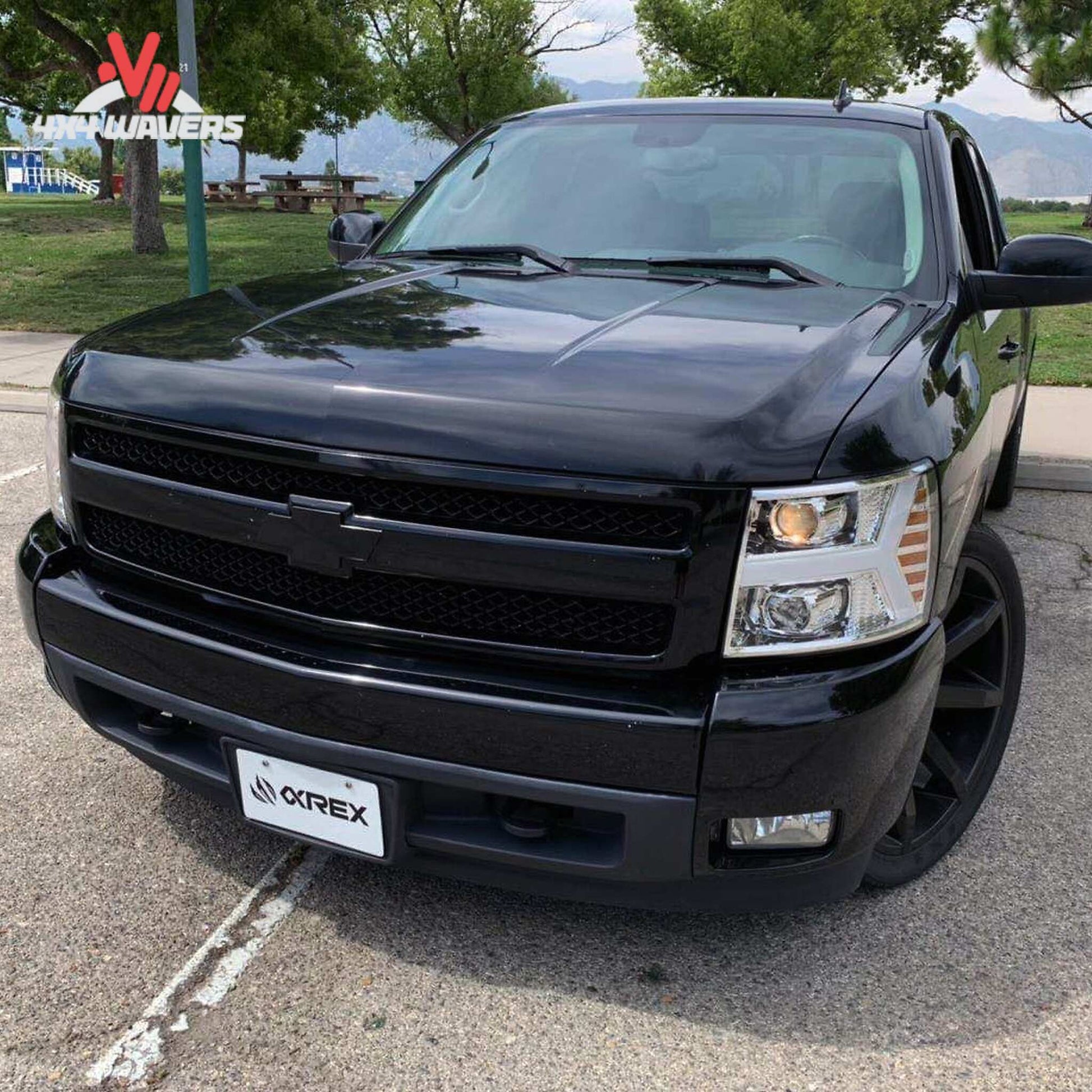 Front end of silver Chevrolet Silverado featuring installed chrome projector headlights SKU 880204