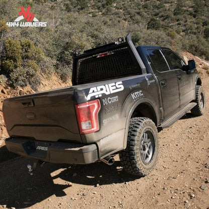 Rear perspective view of a Ford F-150 truck fitted with an ARIES AdvantEDGE black aluminum cab protector rack SKU BBDR_1110102.