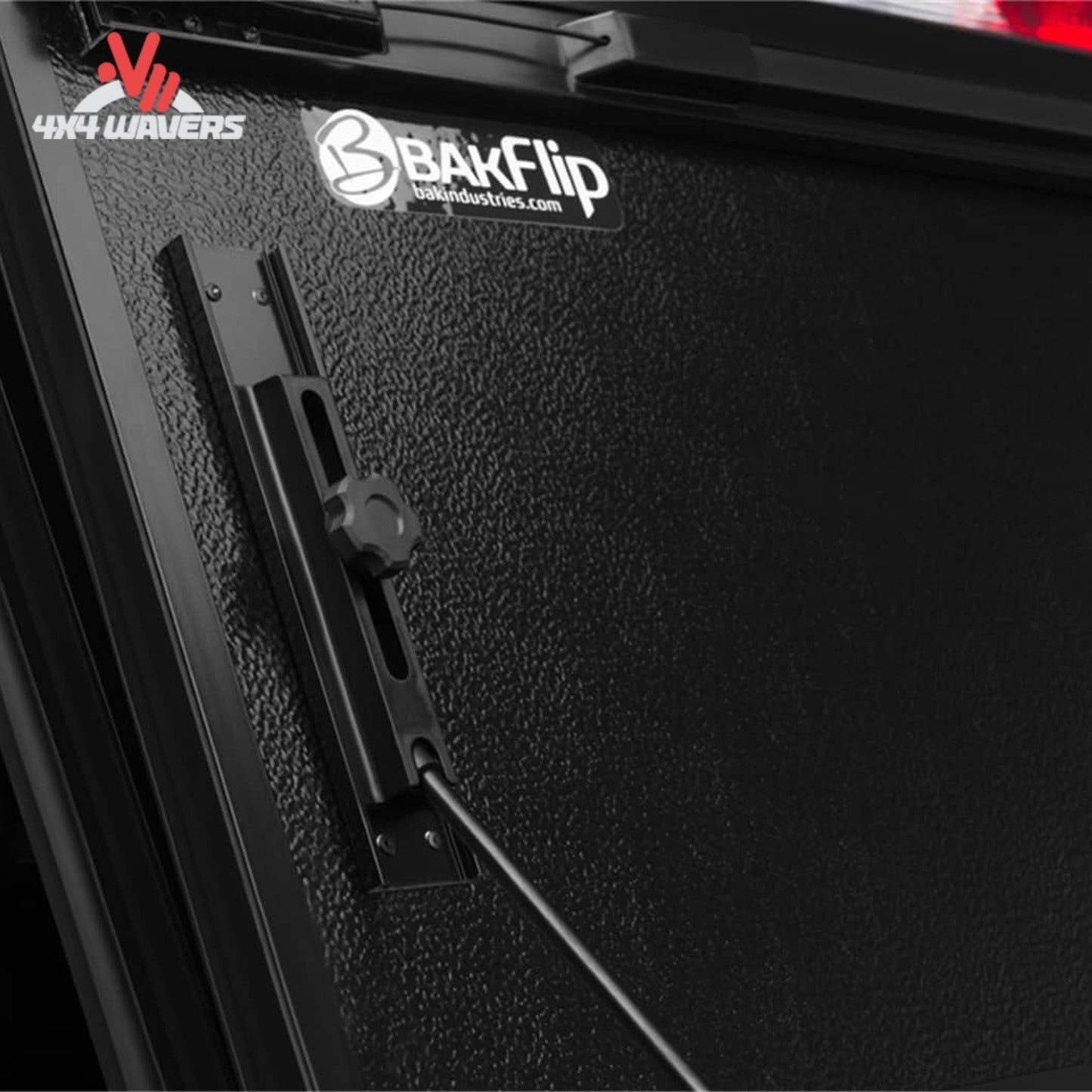 Close-up of BAKFLIP FiberMax hard folding tonneau cover with textured fiber-reinforced panel on a 15-20 Ford F-150 with 6.5' bed