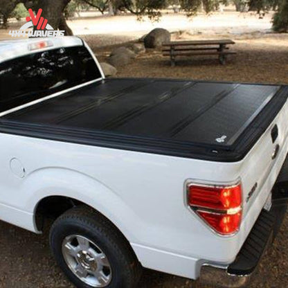 BAKFLIP FiberMax hard folding tonneau cover with textured fiber-reinforced plastic panels on a 15-20 Ford F-150 6.5' bed.