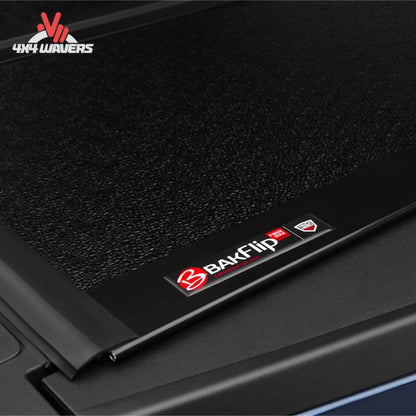 BAKFLIP MX4 hard folding tonneau cover on a 2015-2020 Ford F-150 Raptor 5.5' bed, showing dual-action tailgate seal.