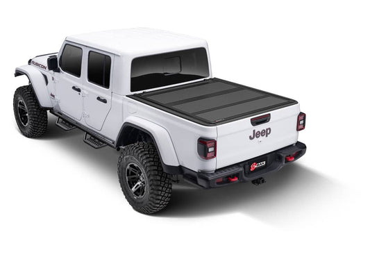 BAKFlip MX4 hard folding tonneau cover in matte aluminum on Jeep Gladiator 5ft bed, featuring tailgate lock system and 400lb capacity