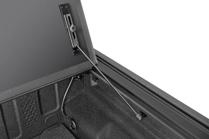 Close-up of the BAKFlip MX4 TS hard folding tonneau cover with T-slot rails on a Jeep Gladiator 5ft bed, showing heavy-duty aluminum construction.