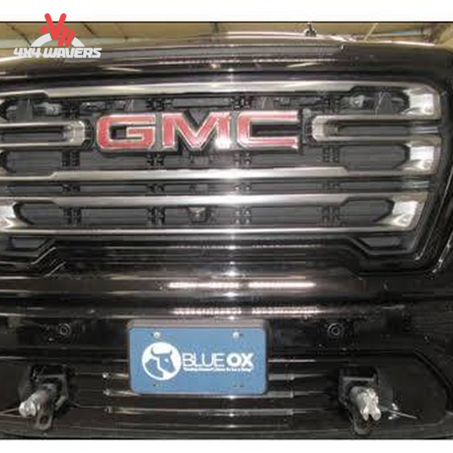 Removable attachment tabs protruding cleanly through front bumper openings on Sierra 1500 SKU BX1753