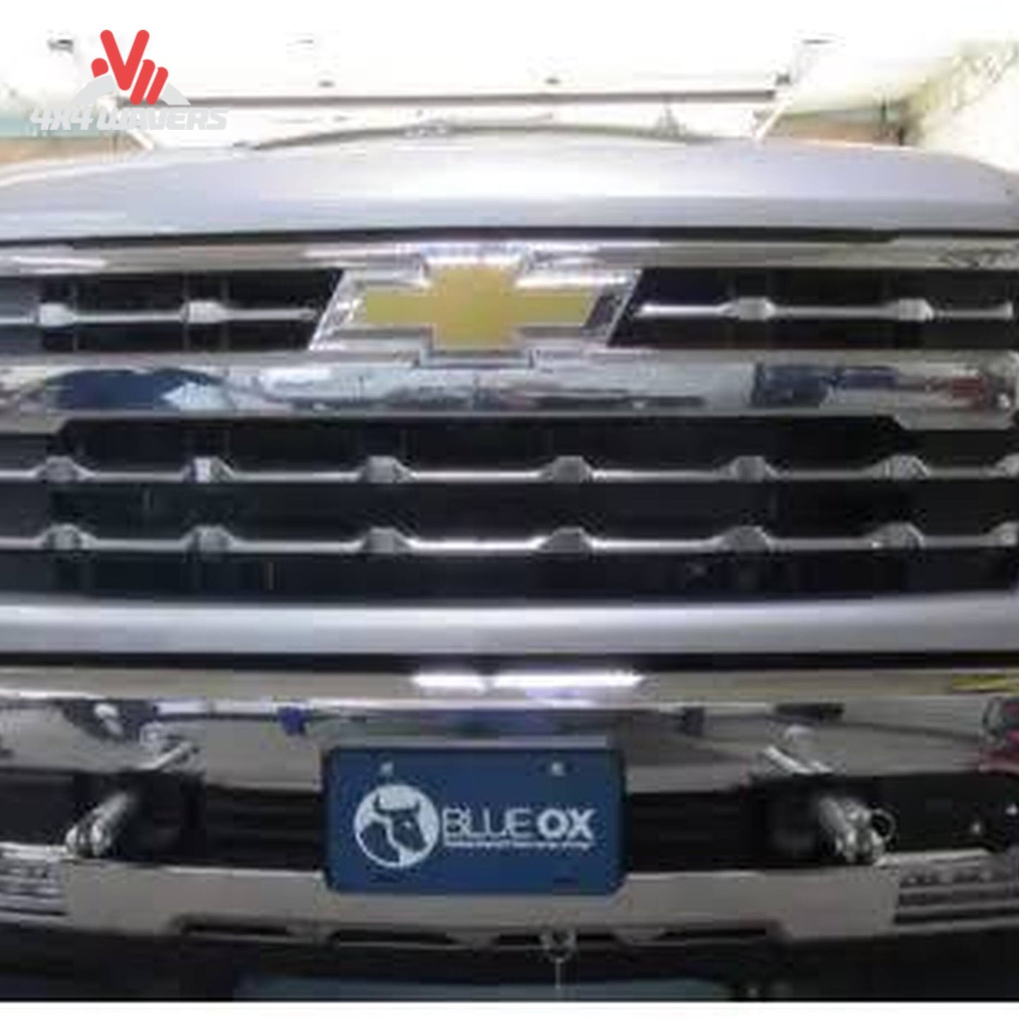 Removable attachment tabs protruding cleanly through front bumper mesh on Silverado 1500 SKU BX1754