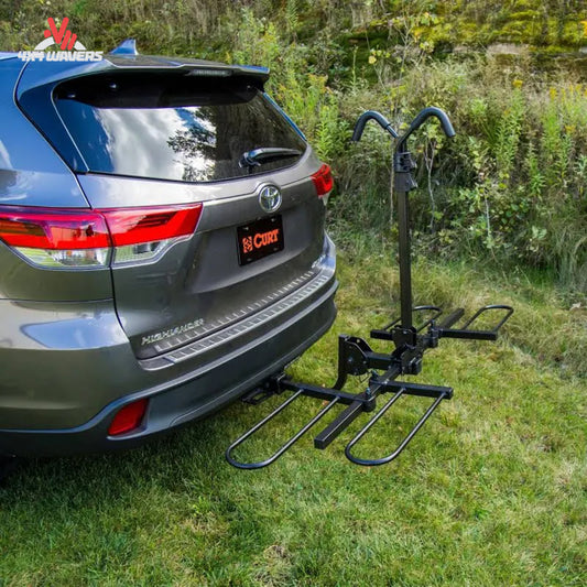 CURT tray-style 2-bike hitch rack installed on SUV, fits 1-1/4" and 2" receivers, designed for secure bike transport.