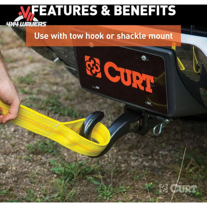 A yellow CURT tow strap being attached to a black hitch on a vehicle, with a hand holding the strap. The image includes a CURT logo