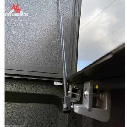 Close-up of Dura-Flip Hard Folding Tonneau Cover quick-release clamps on a Ford F150 6.5ft bed, showing secure attachment details.