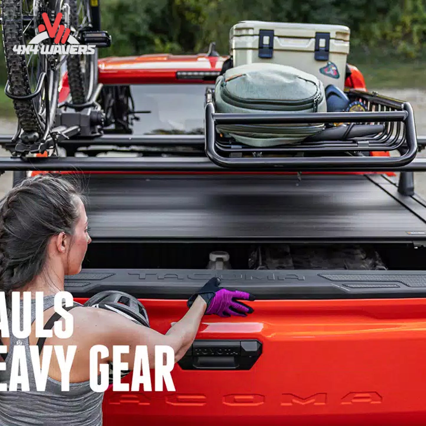 RealTruck Elevate cargo basket installed beside bike and kayak carriers on an adventure vehicle