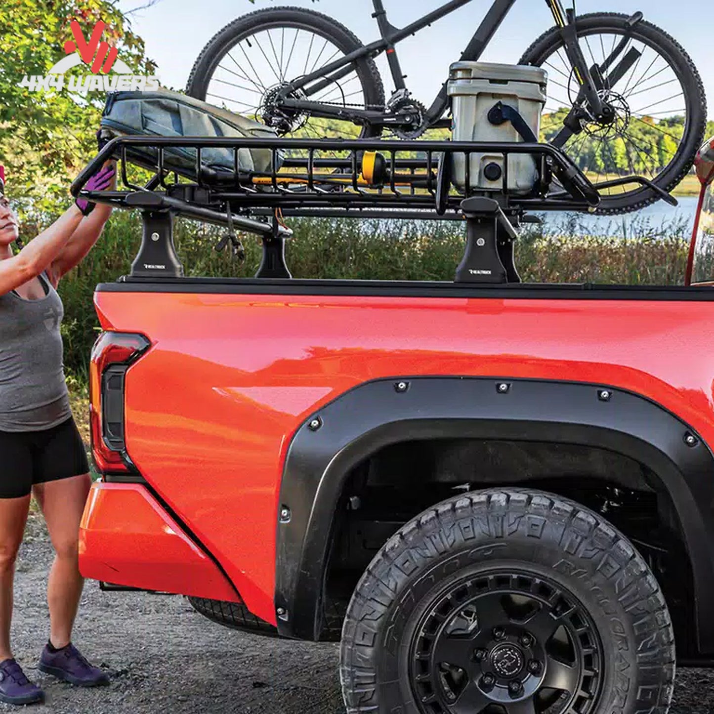 RealTruck Elevate cargo basket installed beside bike and kayak carriers on an adventure vehicle