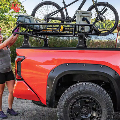 RealTruck Elevate cargo basket installed beside bike and kayak carriers on an adventure vehicle