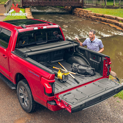 Extang Trifecta 2.0 tonneau cover folded open on a 2009-2014 Ford F-150 with a 5.5ft bed, showcasing bed access and cover design.