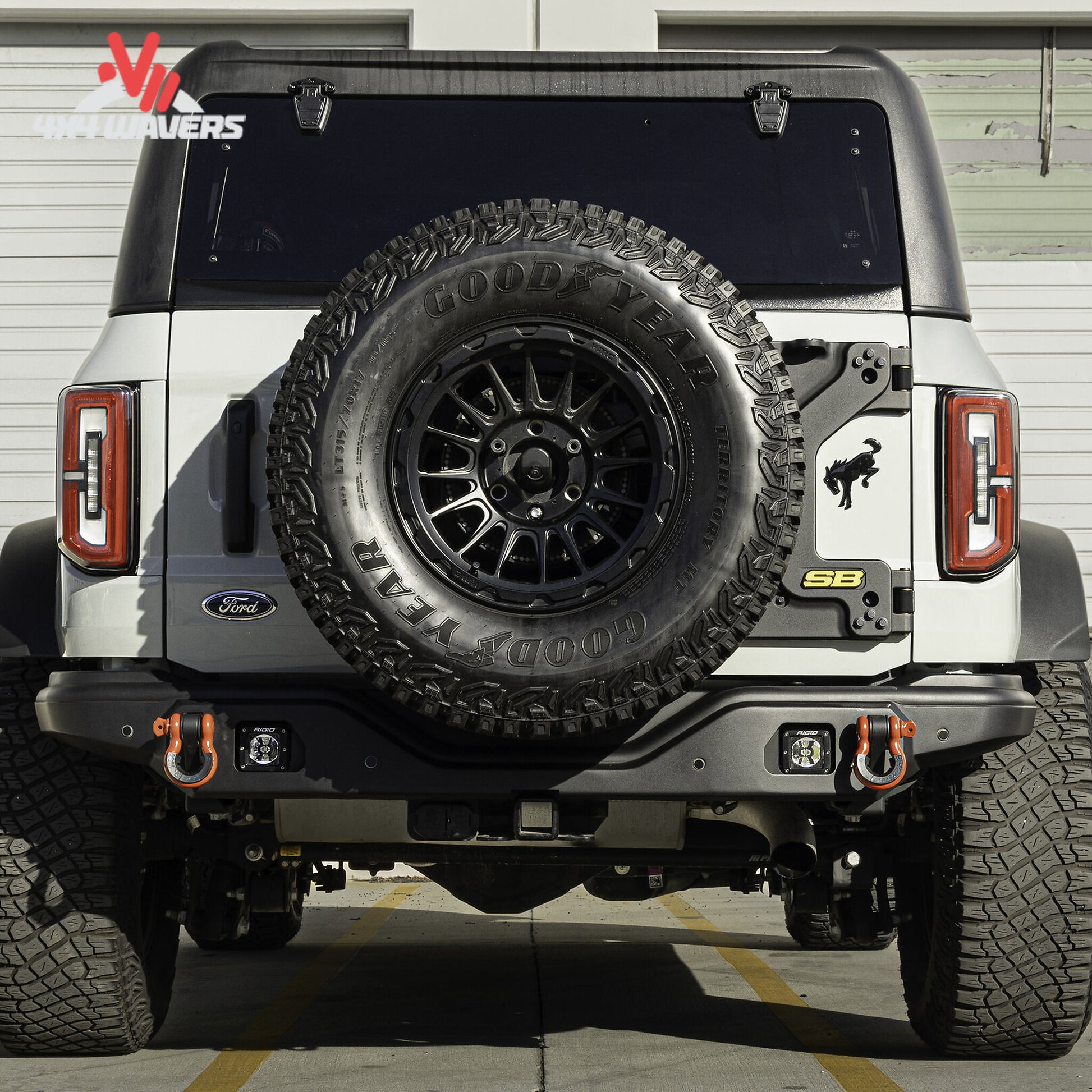 Rear view of a Ford Bronco showing the Smittybilt XRC bumper with factory sensor integration