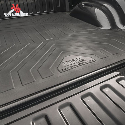 Husky Liners heavy-duty rubber bed mat for 2015-2026 Ford F-150 5.5 ft bed, showing durable textured surface and tailored fit.