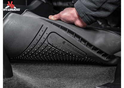 Close-up of black Husky WeatherBeater TPO floor liners for 2018-2025 Jeep Wrangler JL 4-door, showing textured surface and fit.
