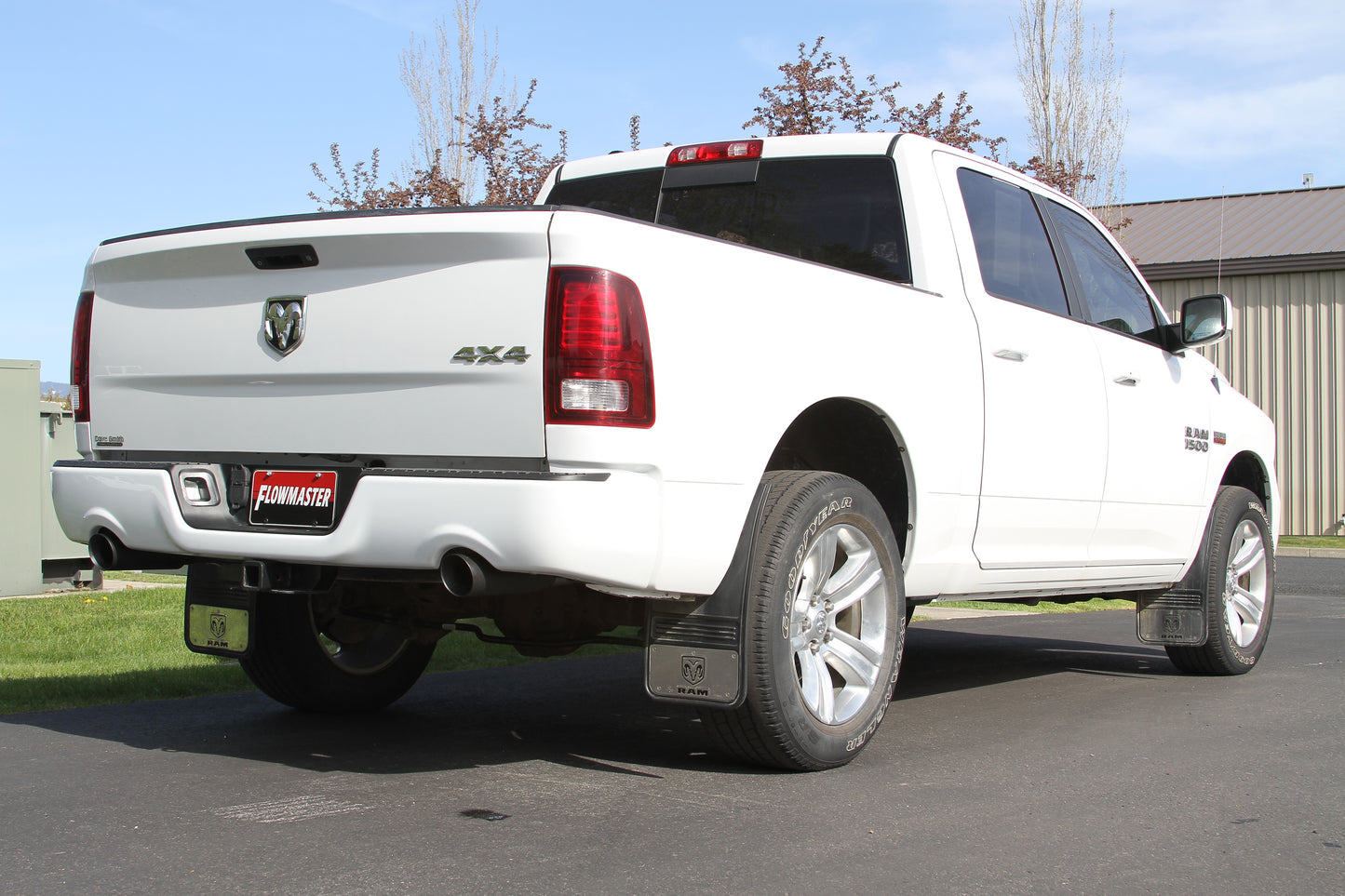 Flowmaster Outlaw Cat-back Exhaust System Kit showing polished stainless steel pipes and dual exhaust tips on a vehicle.