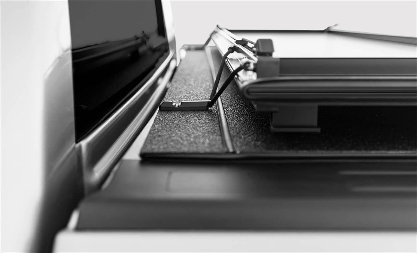 Open black LOMAX STANCE hard folding tonneau cover on 2020-2026 Jeep Gladiator with Trail Rail System, showing its sturdy design.