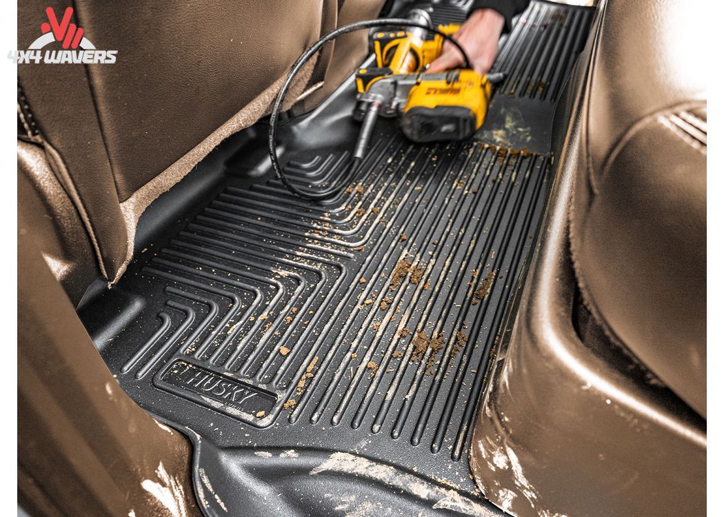 Black Husky WeatherBeater floor liners for 2018-2025 Jeep Wrangler JL 4-door, providing all-weather off-road protection.