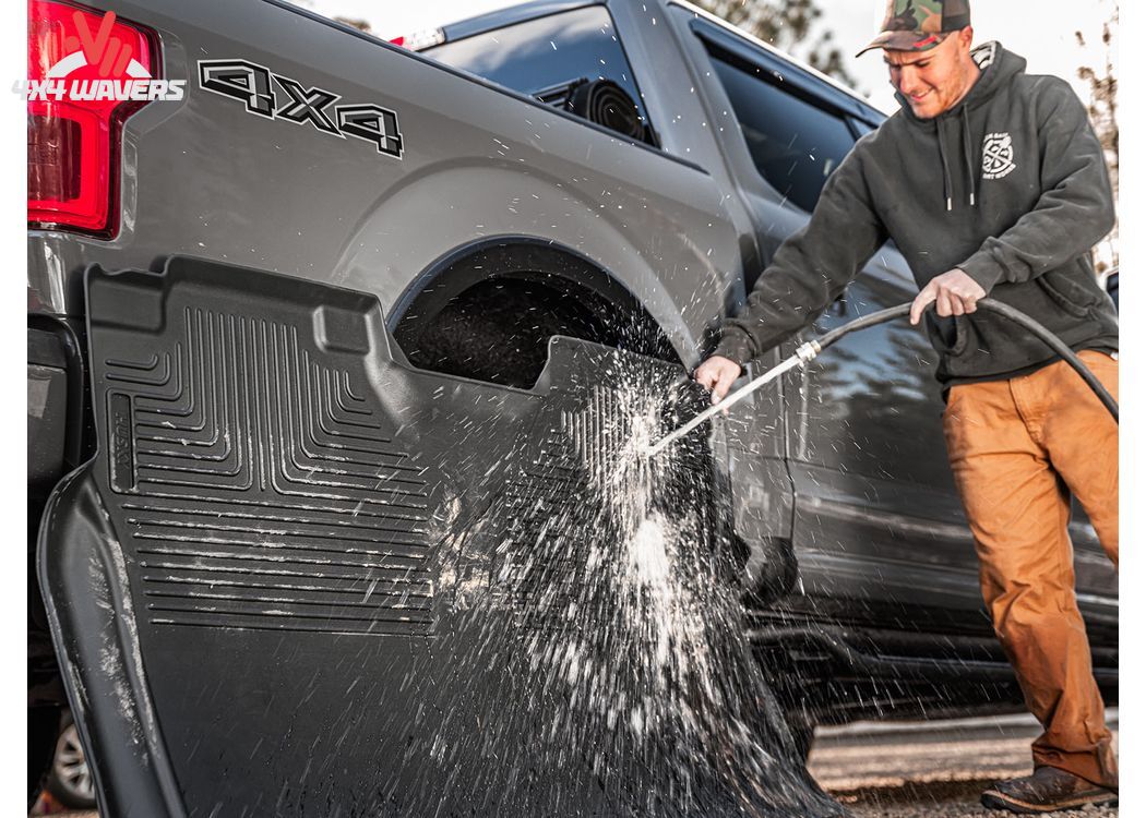Black Husky WeatherBeater floor liners for 2018-2025 Jeep Wrangler JL 4-door, all-weather off-road protection.