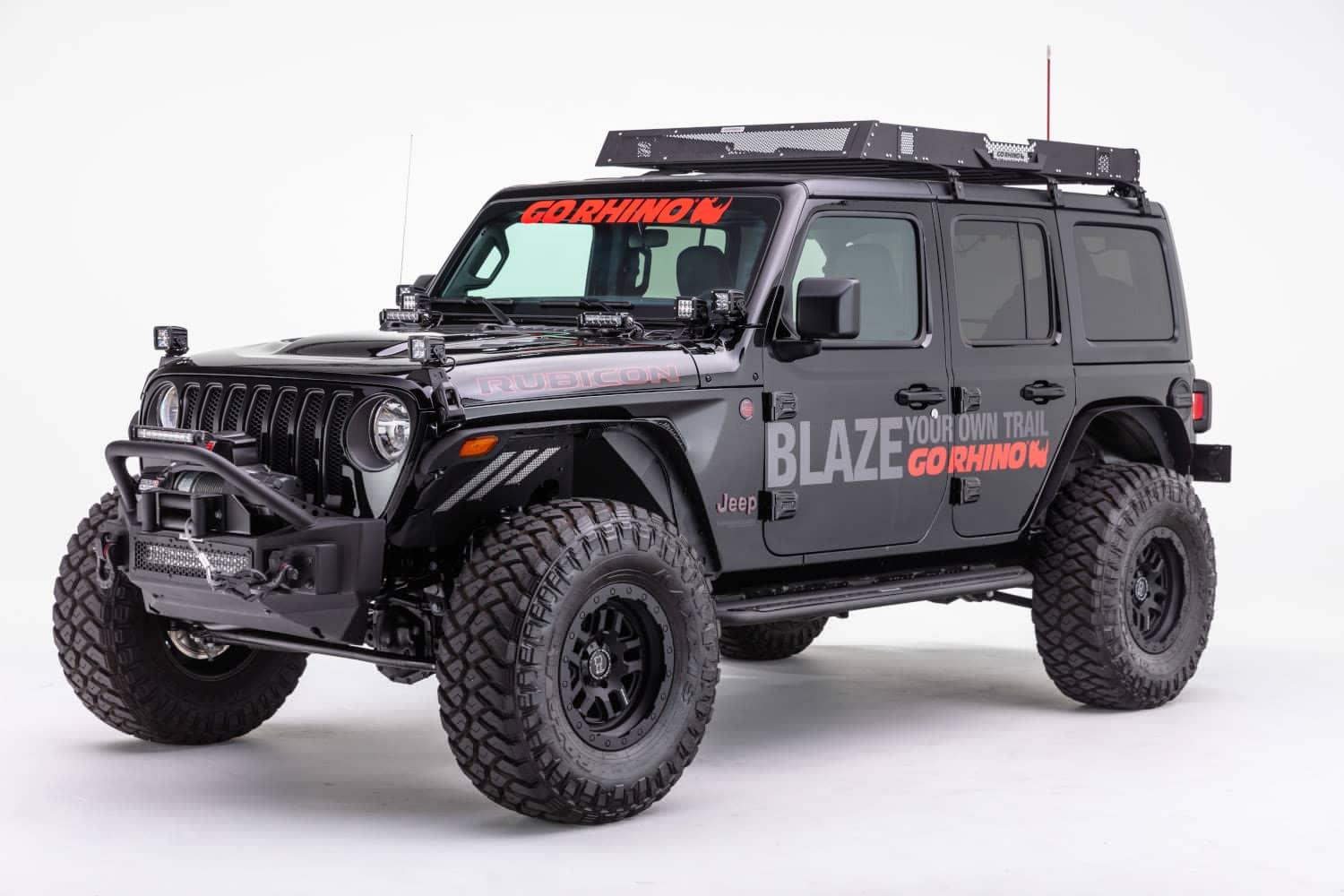 Go Rhino Rockline Stubby front winch bumper with overrider bar on a Jeep JL or Gladiator JT, showing the angled view of the bumper.