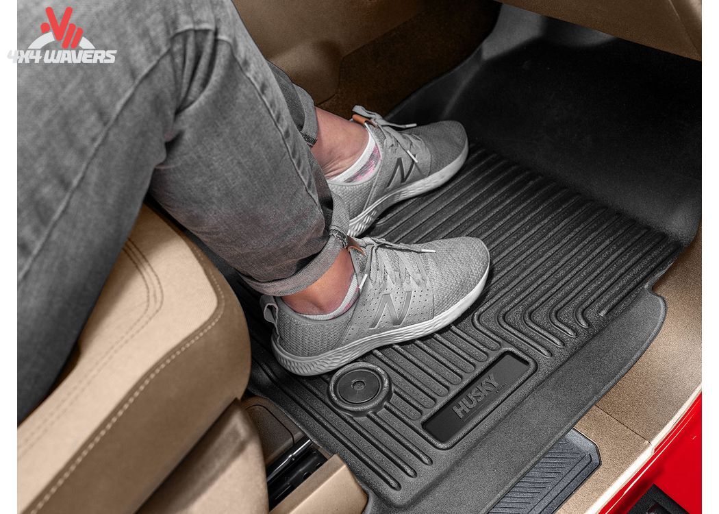 Husky WeatherBeater black floor liners installed in the second row of a 2018-2025 Jeep Wrangler JL 4-door SUV.