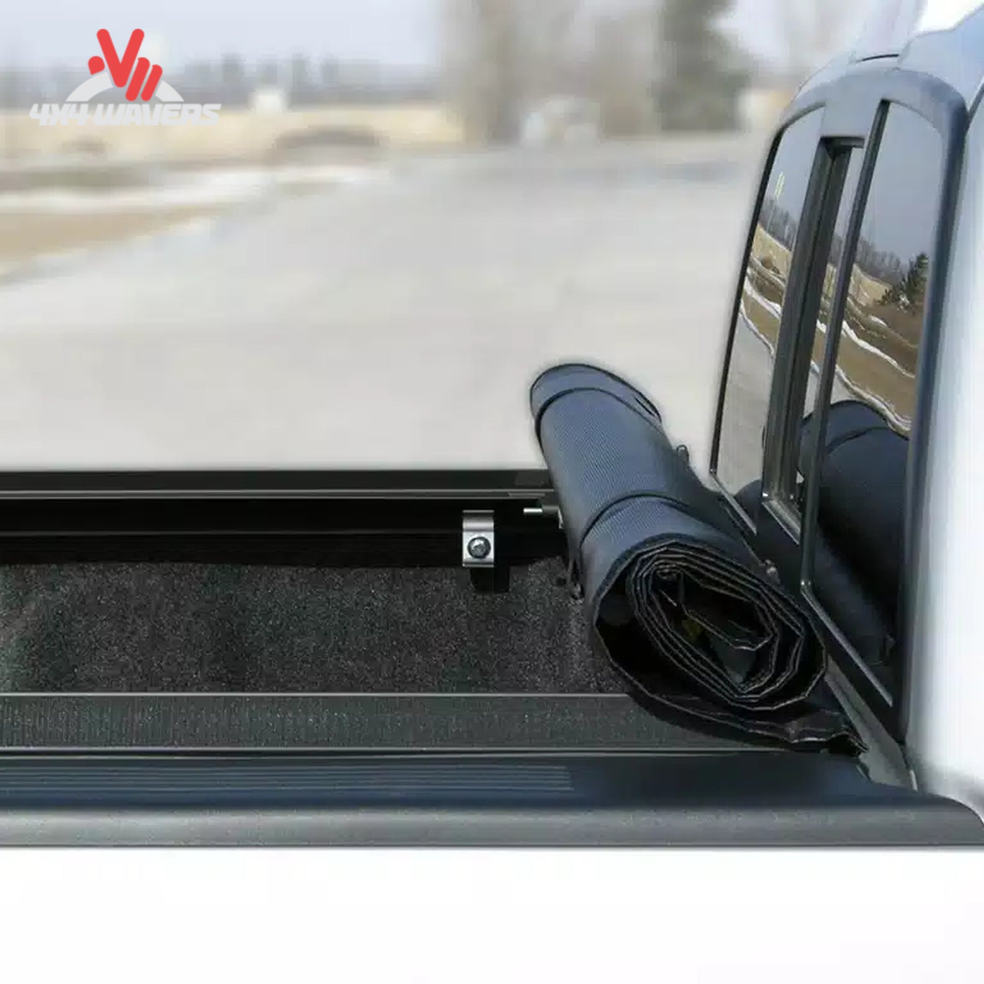 A 6.5 foot soft vinyl tonneau cover completely rolled up behind the truck cab showing open bed access SKU BGPC_31379.