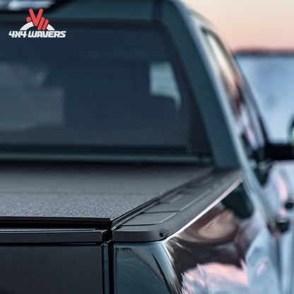 Close-up detail of the impact resistant black finish and heavy duty weather hinges on a hard tonneau.