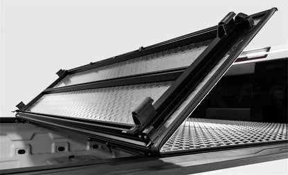 Open view of ACI LOMAX hard folding tonneau cover on 2020-2026 Jeep Gladiator 5ft bed with Trail Rail system, black low profile finish.