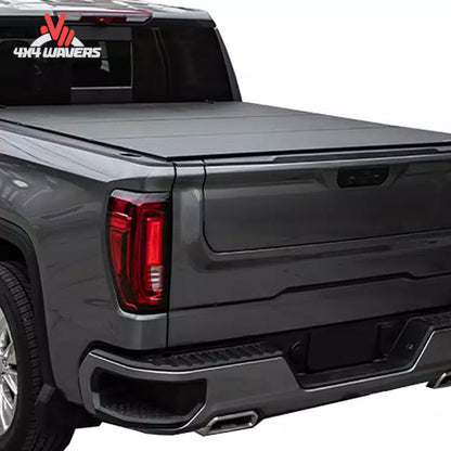 An ultra low profile vertical folding hard truck bed cover mounted flush on a standard box silver Ford F-150.
